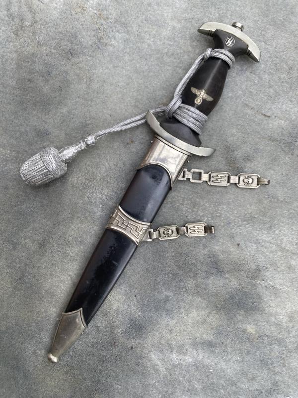 AN EARLY ALL NICKEL SS 1936 CHAINED DAGGER WITH PARTIAL CHAINS.