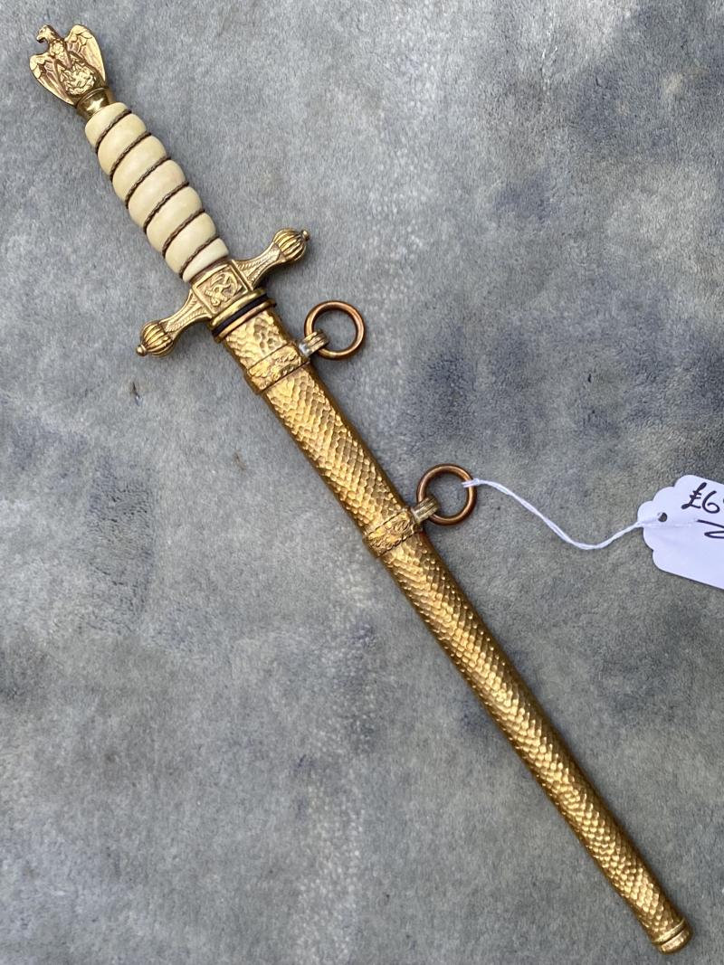 NEAR PERFECT EXAMPLE OF NAVY DAGGER BY HOLLER WITH HAMMERED SCABBARD.