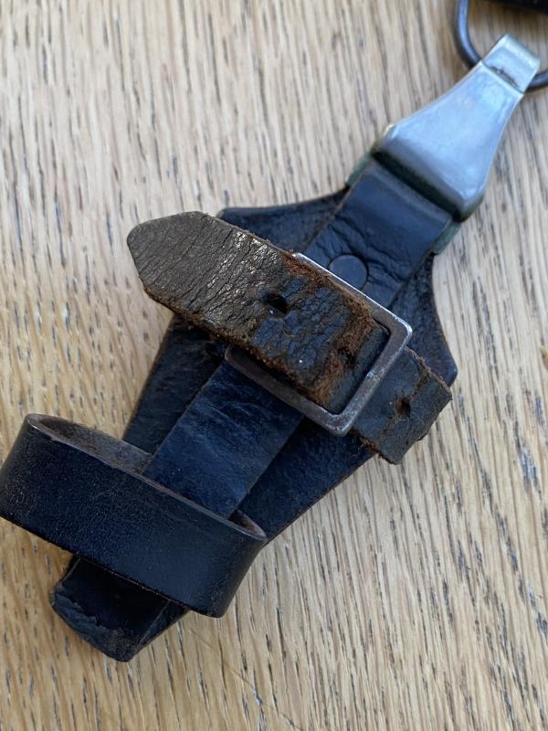 AN ORIGINAL- MARKED BLACK SS VERTICAL DAGGER HANGER.