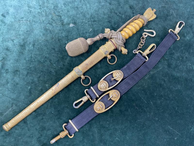 A WONDERFUL NAVY DAGGER BY WKC WITH ORANGE GRIP, HAMMERED SCABBARD, KNOT AND ORIGINAL HANGERS.