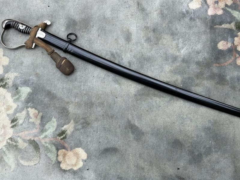 A TRIPLE ETCHED GERMAN DOVE HEAD SWORD BY WEYERSBERG.