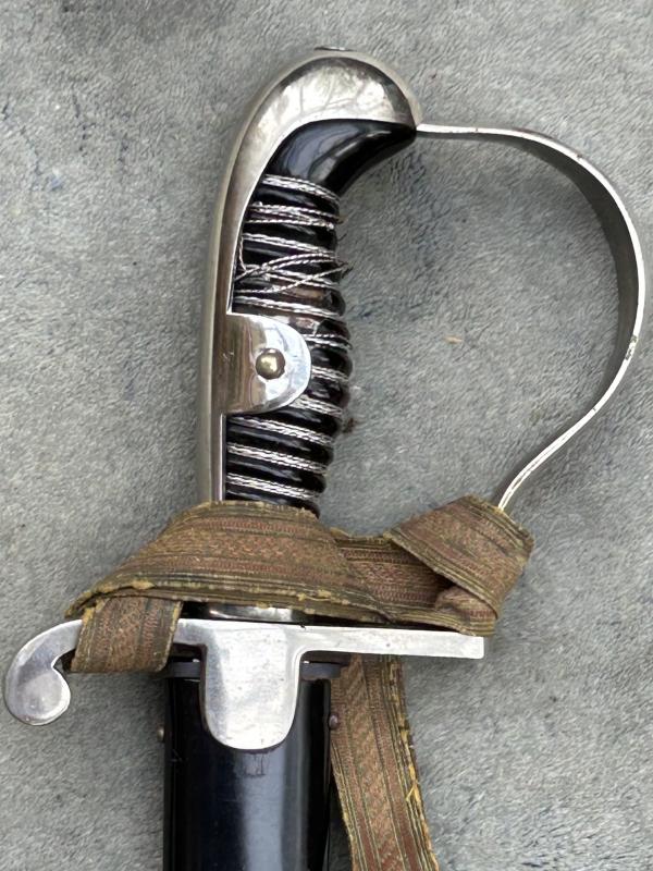 A TRIPLE ETCHED GERMAN DOVE HEAD SWORD BY WEYERSBERG.