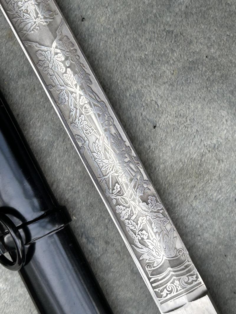 A TRIPLE ETCHED GERMAN DOVE HEAD SWORD BY WEYERSBERG.