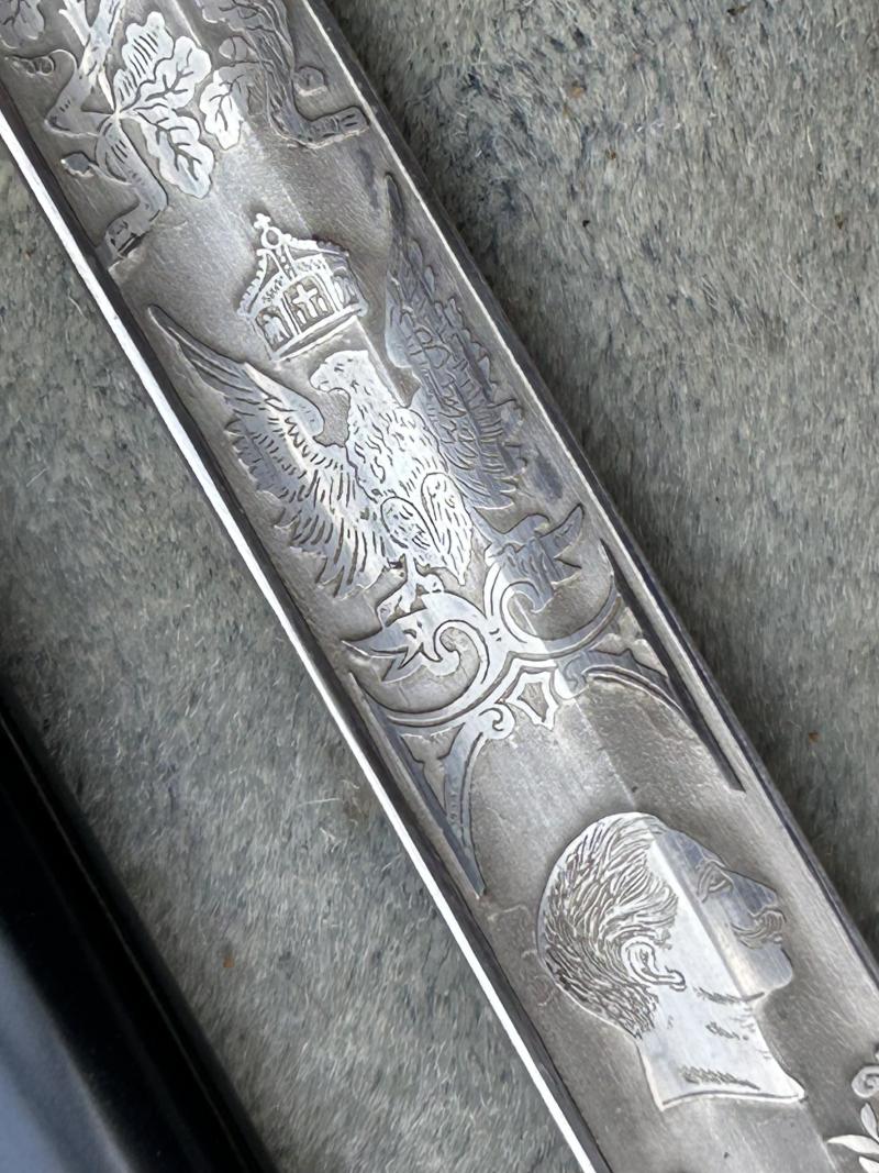 A TRIPLE ETCHED GERMAN DOVE HEAD SWORD BY WEYERSBERG.