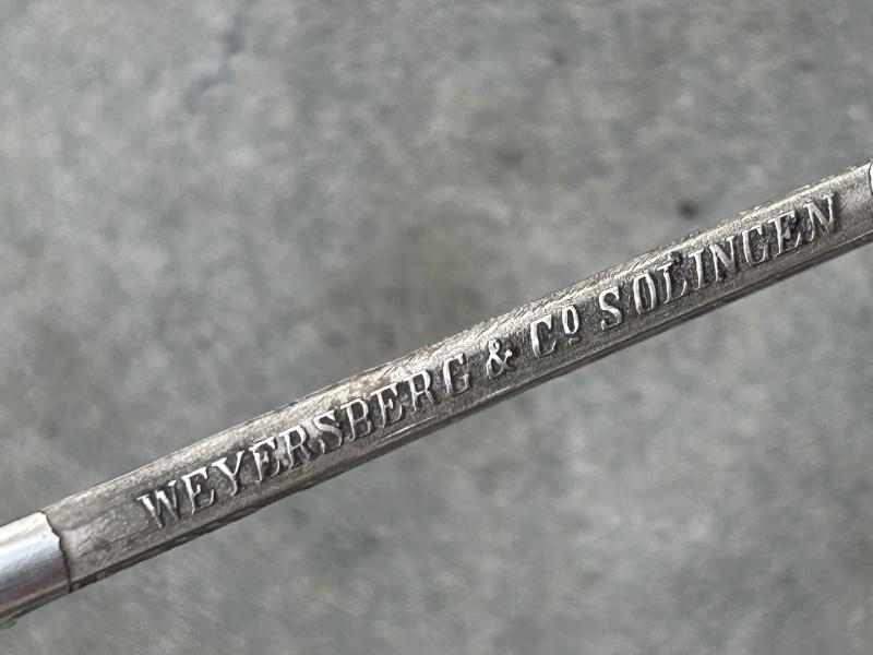 A TRIPLE ETCHED GERMAN DOVE HEAD SWORD BY WEYERSBERG.