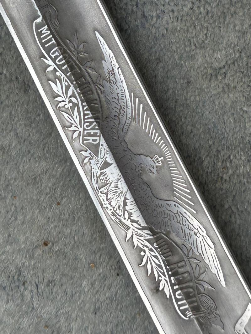 A TRIPLE ETCHED GERMAN DOVE HEAD SWORD BY WEYERSBERG.