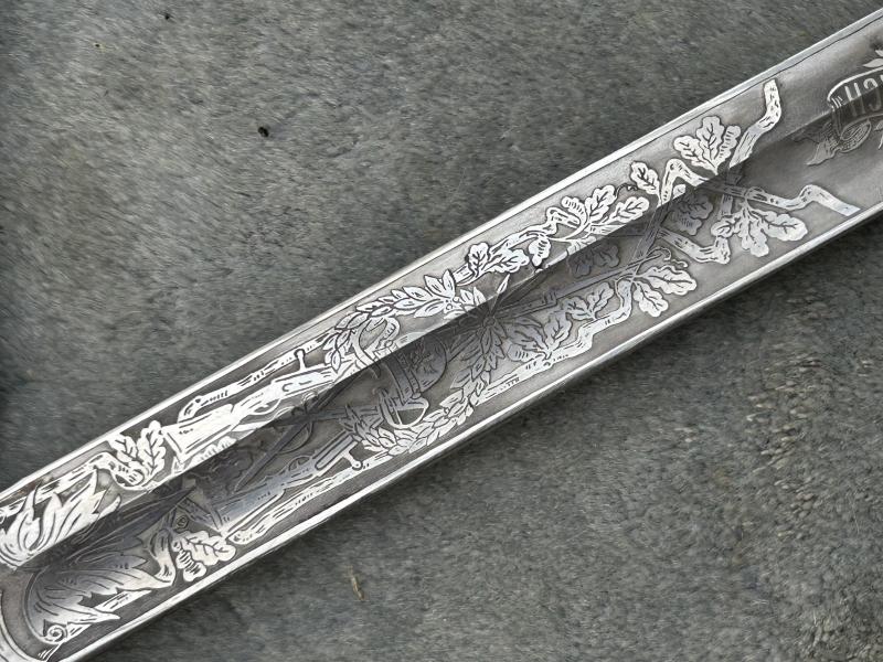 A TRIPLE ETCHED GERMAN DOVE HEAD SWORD BY WEYERSBERG.